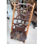 A carved and pierced African tribal folding chair, figures and hippopotami to the back