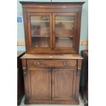 A Victorian mahogany full height bookcase with moulded cornice and double glazed doors over frieze