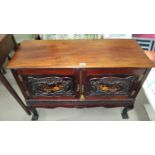 An Edwardian mahogany side cabinet enclosed by 2 doors, with extensive relief carved and floral