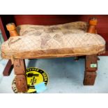 A vintage camel stool with metal studding