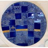 A studio pottery charger in blue, with relief decoration squares mixed with flat glaze,