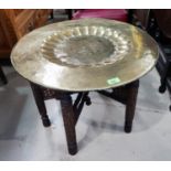 A circular brass top Eastern occasional table; a nest of 3 oak occasional tables