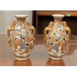 A pair of early 20th century Satsuma baluster vases decorated with male and female figures