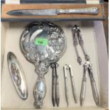 A silver backed hand mirror, a silver handled cased knife and a silver buffer and four plated nut