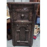 A Victorian oak straight front corner cupboard with extensive "Gothic" carved decoration