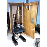 A brass and japanned metal microscope by Hearson, London, No 154, in oak case