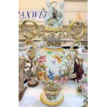 A large Majolica style covered 2 handle urn shaped vase on a stand, the body with polychrome