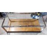 A MERROW ASSOCIATES coffee table with chromed metal mounts and a plate glass top