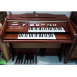 A Technics U30 electric organ with twin keyboard in mahogany effect case, with stool