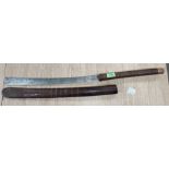 A Polynesian weapon with blade and wrapped handle, wooden sheath, length 76cm