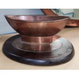 An Arts & Crafts Copper Table Centre, in the form of a boat, on a wooden stand. Length 33cm.