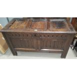 A late 17th century/early 18th century framed and panelled oak bedding box with carved decoration to