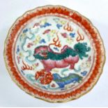 A late 19th/early 20th century Chinese circular dish decorated with dragons, etc., on raised foot,