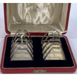 A hallmarked silver pair of 4 division toast racks, cased, Birmingham 1939, 4.5 oz