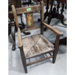 A child's oak rush seat chair with transfer decoration and a stained wood corner armchair