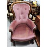 A Victorian mahogany spoon back armchair in buttoned pink dralon