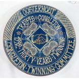 A studio pottery charger, doric blue ground with fawn and brown slipware lettering celebrating