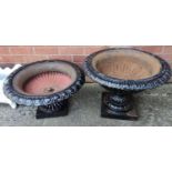 Two circular metal garden pedestal planters