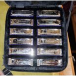 A set of 12 Johnson 'The Blues King' harmonicas in carry case