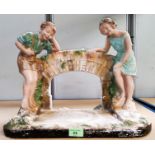 A 1930's plaster group:  2 children by a bridge; other decorative china and collectors items