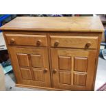A good quality heavy oak Cotswold style side cabinet with 2 cupboards and 2 drawers, with carved
