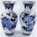 An oriental pair of fluted baluster vases in blue and white with flowering branch decoration, height