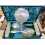 A hallmarked silver backed 5 piece dressing table set, engine turned, cased, Birmingham 1915 (mirror