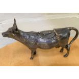 A white metal cow creamer with fly design to back of hinged lid, marked 925, 6.4gm