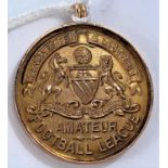 A 9ct gold Manchester & District Amateur football league medal, 6.5gms