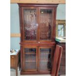 A 19th century mahogany full height bookcase, the upper and lower sections enclosed by twin leaded