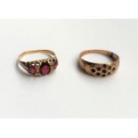 A 9 carat ring set with 3 garnets (a.f.- marks worn); a 9 carat hallmarked gold gypsy ring (stones