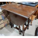 A mahogany occasional table with oval drop leaf top