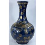 A Chinese blue ground vase with gilt decoration & highlights, with character marks to base, height