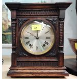An architectural oak cased striking mantel clock