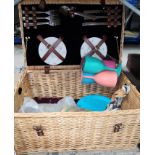 A wicker picnic hamper with fittings and another