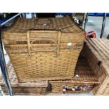 A wicker picnic basket with fittings and another