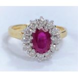 An 18ct hallmarked gold cluster dress ring with central ruby surrounded by 12 diamonds, 5.6gms