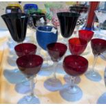 A selection of cut glass coloured drinking glasses, mainly wines