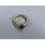 A yellow metal ring, no stone, 5.4gm tests as ***