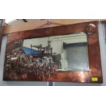 An Arts and Crafts copper framed wall mirror with embossed decoration of a moonlit coach and horses,