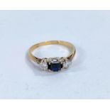 A lady's dress ring set with square cut sapphire flanked by 2 diamonds, 18k, size L , 2.24gms