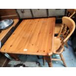 A pine kitchen table with rectangular top; 2 spindle back chairs