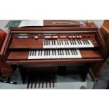 A Technics U30 electric organ with twin keyboard, in mahogany effect case, with stool