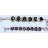 A white metal bracelet set with 6 oval facetted smoky quartz, stamped '925'; a white metal