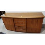 A 1970's teak sideboard of 2 cupboards and 5 central drawers