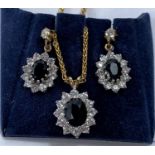 A sapphire and simulated diamond cluster pendant and earring; a 9 carat hallmarked gold, chain