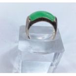 A white metal dress ring set with rounded oblong jade coloured stone, stamped '925' 5.66gms size O/P