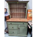 A 19th century pine kitchen dresser in 'antique' green finish, with 2 height delft rack, 3 drawers