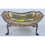 A shaped rectangular dish with pierced border, on shaped legs, Sheffield, 9.5 oz