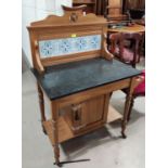 An Edwardian small washstand in satin beech with marble top and tile back